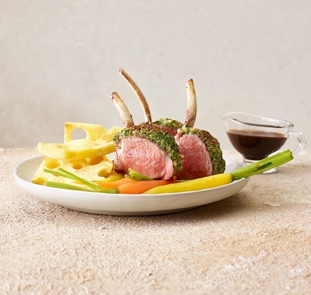 Carré d'agneau rosé en croûte aux fines herbes, pommes de terre à l'emmentaloise et carottes glacées